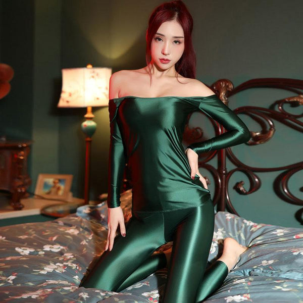 front view of lady wearing green shiny wet look top & legging set featuring a shiny wet look top with off shoulder neck line and long sleeves and a matching legging. 