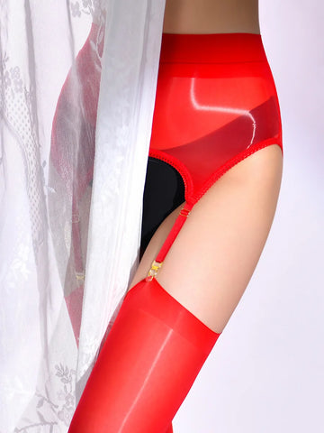 A woman posing in a red glossy sheer thigh high stockings with matching glossy garter belt.
