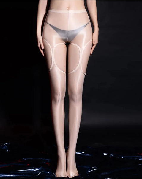 A woman wearing beige glossy suspender pantyhose and panties.