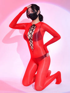 A woman posing in red long sleeves sheer glossy bodystocking, with front and back criss cross strappy detailing.