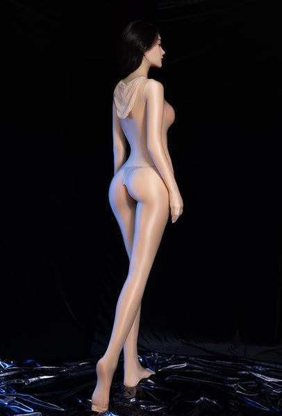 A women posing in a beige glossy sheer bodystocking with long sleeves, closed hand design, attached over the head hood, and open crotch.