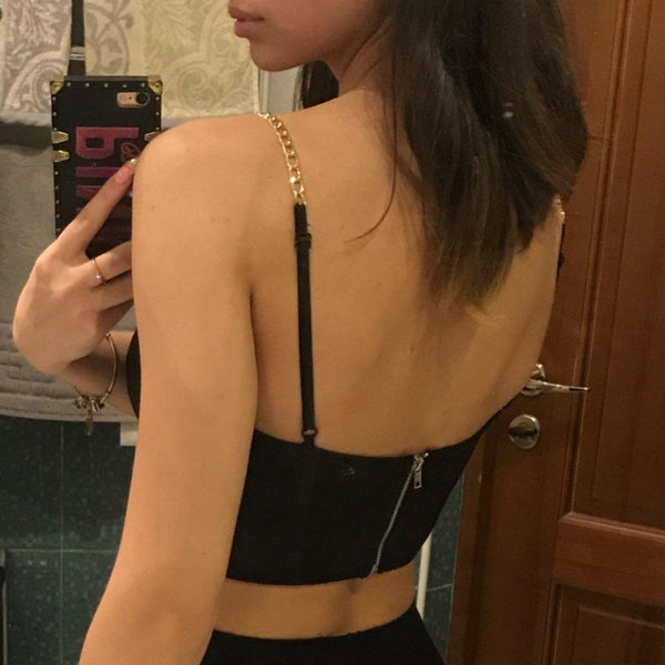 Black sexy corset crop top featuring a adjustable shoulder straps, back zipper closure and a low cut back. 