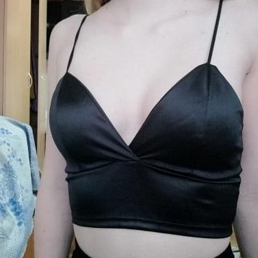 black satin bralette featuring a soft cups, spaghetti straps and plunging V-neckline, hook and eye closure.