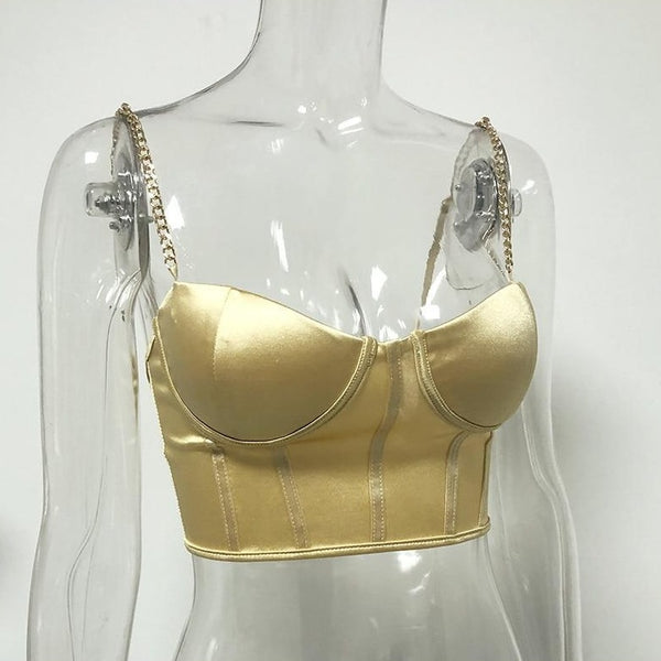 Gold sexy corset crop top featuring a adjustable shoulder straps, back zipper closure and a low cut back. 