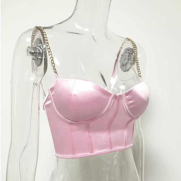 Pink sexy corset crop top featuring a adjustable shoulder straps, back zipper closure and a low cut back. 