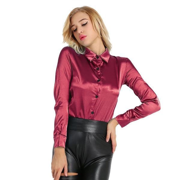 Maroon satin blouse featuring button down closure, long sleeves, fitted silhouette. 